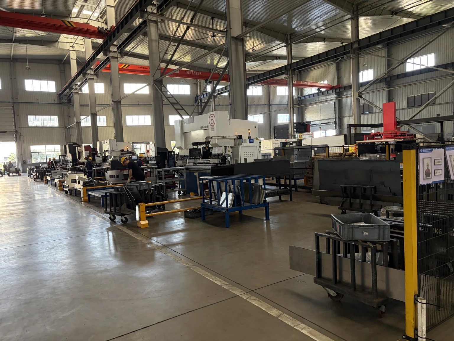 Manufacturing workshop with industrial machinery and employees at work