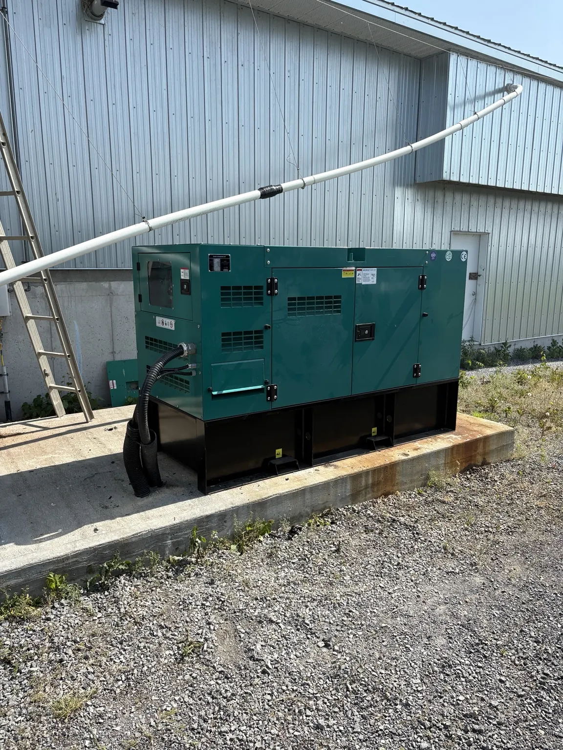Diesel generator installed on a base near a commercial building